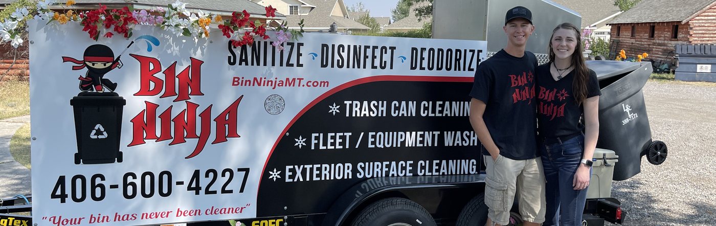 The Bin Ninja service trailer parked on a Montana driveway beside a cleaned wheelie bin