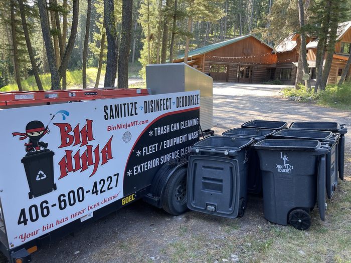 A row of wheelie bins lined up beside the Bin Ninja trailer