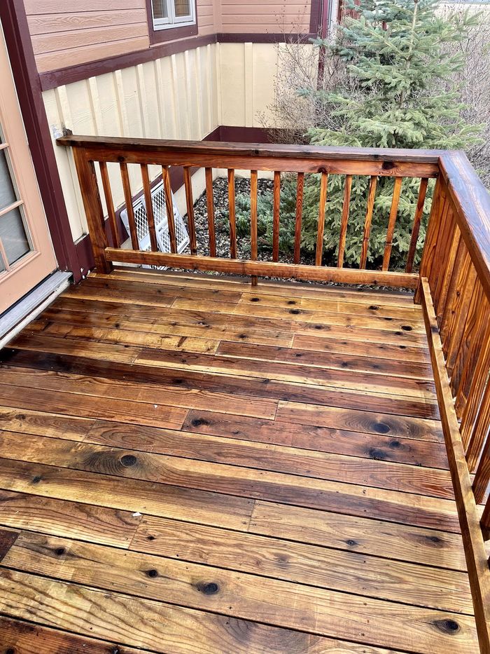 A timber deck restored to a rich colour after power washing