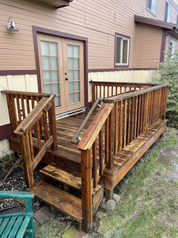 A weathered timber deck and steps before cleaning