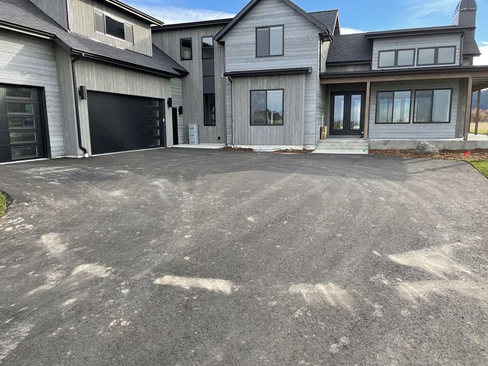 A wide concrete driveway after cleaning