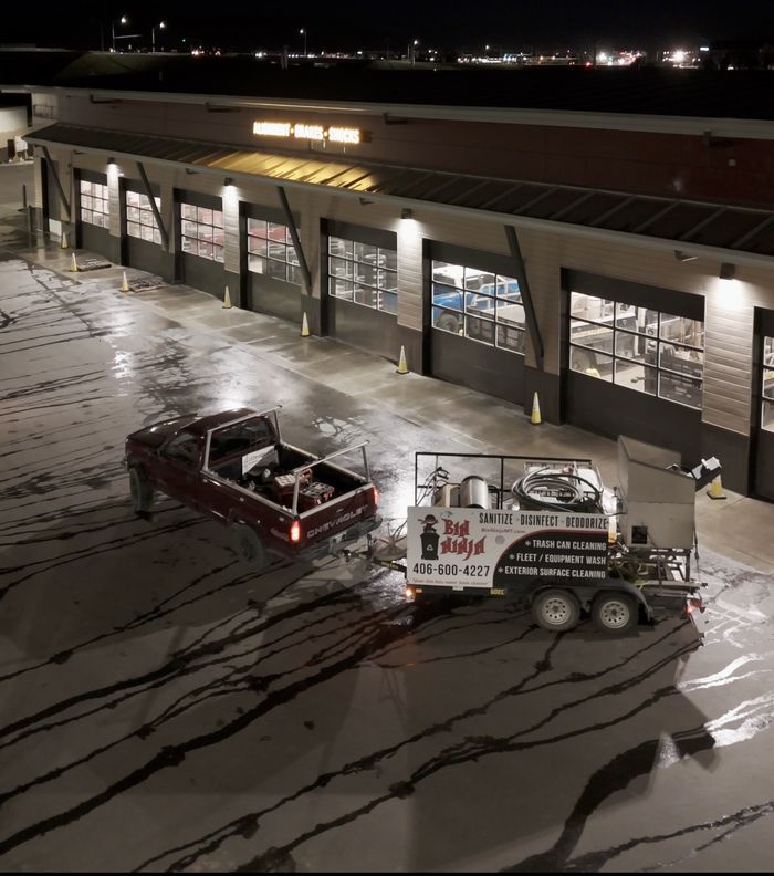 Night-time pressure washing outside a commercial building