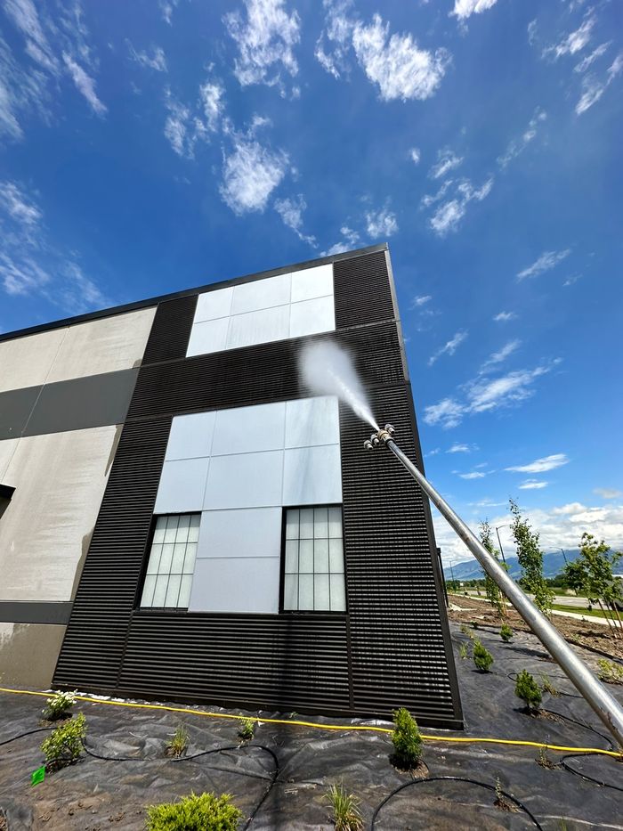 Pressure washing the exterior cladding of a commercial building