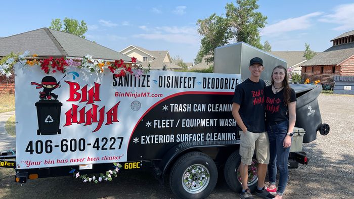 The Bin Ninja team standing beside the branded service trailer