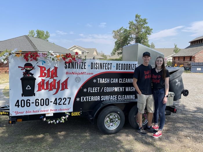 The Bin Ninja team beside the trailer on a summer route day